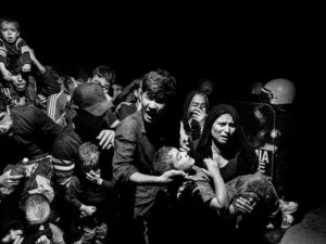 Scene #0410. GREECE. Lesbos. Mytilene. 2015. Refugees and migrants arriving on Lesbos are transferred to the Moria refugee camp where they register with authorities before being able to move on.